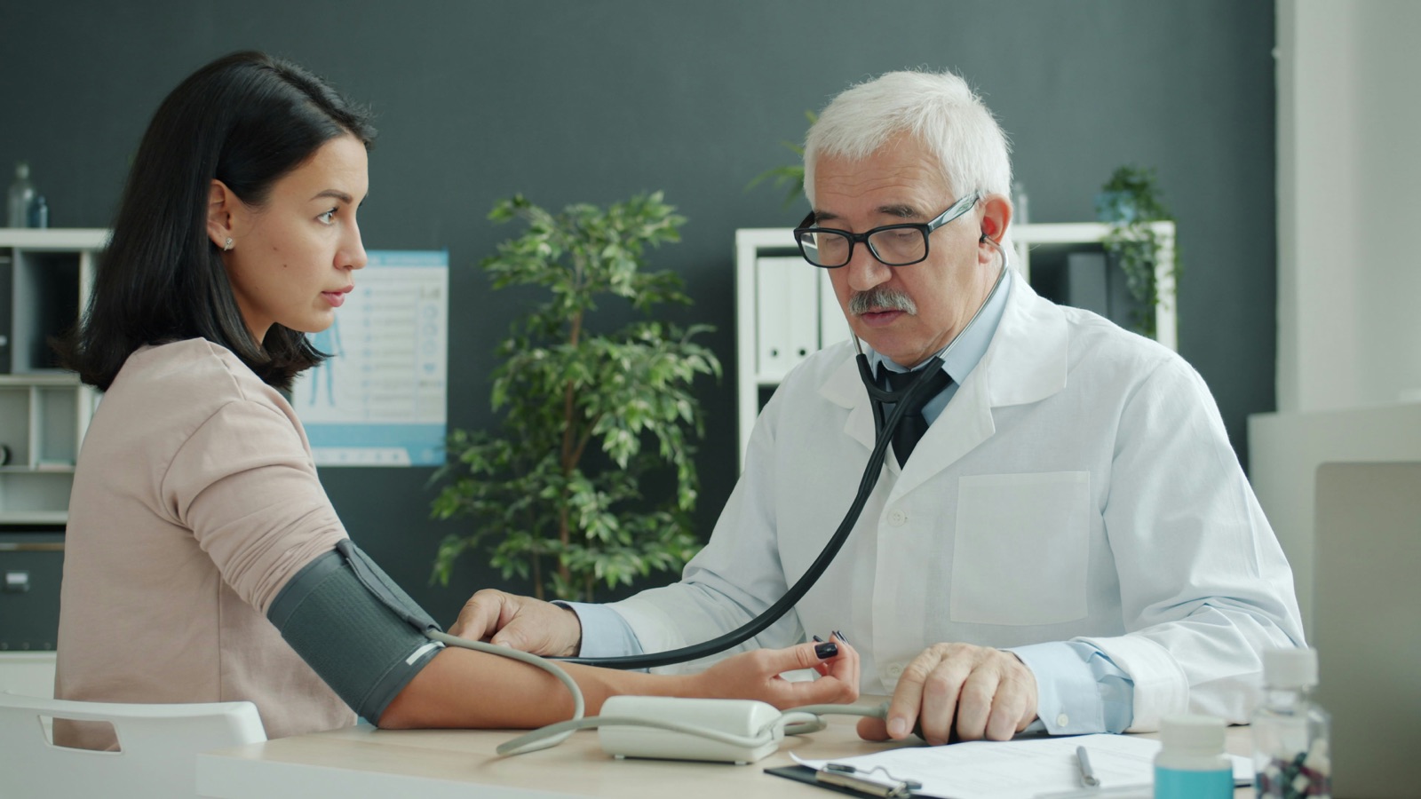A doctor checking a patient’s blood pressure