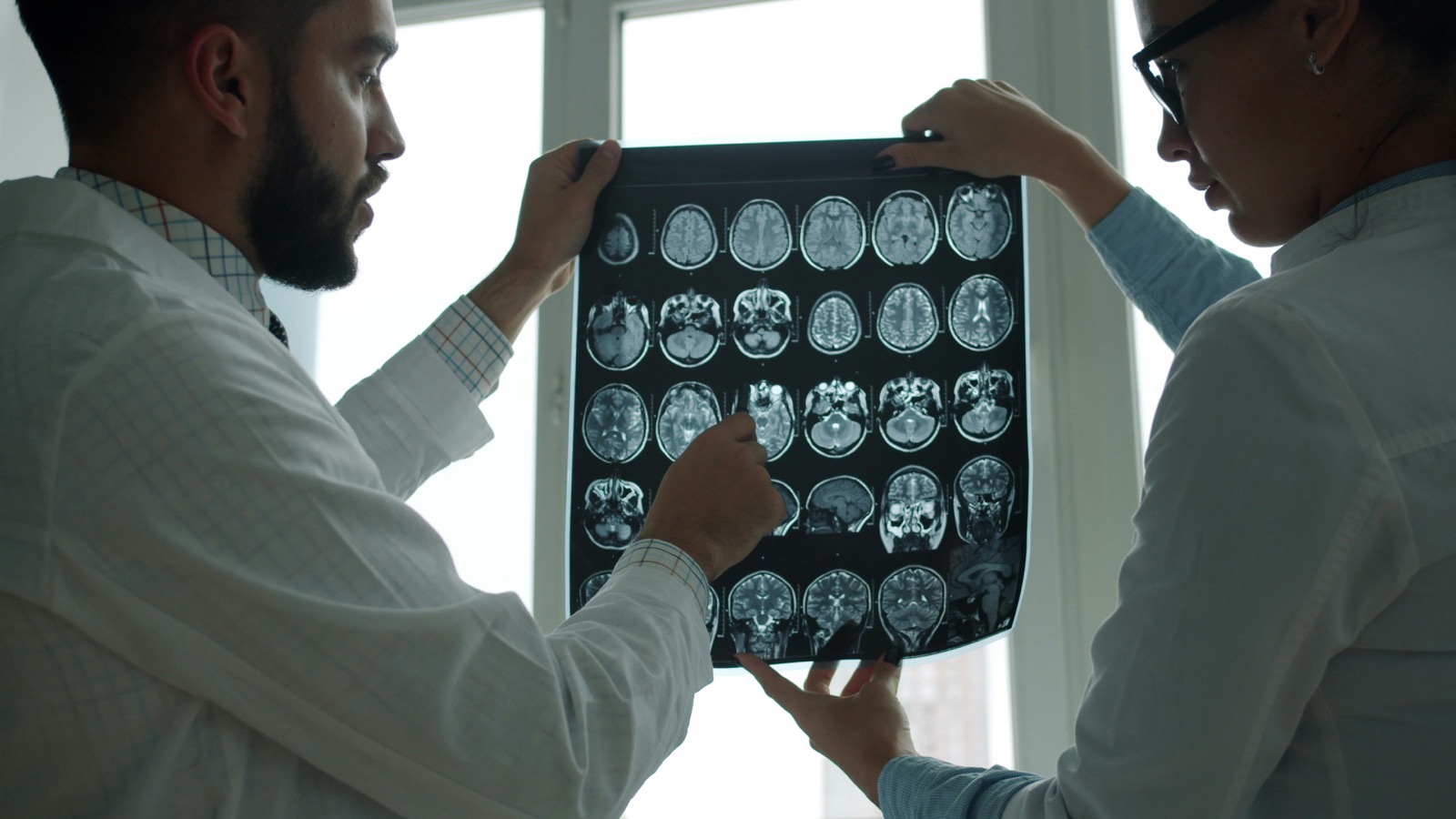 Two doctors reviewing a brain MRI film together
